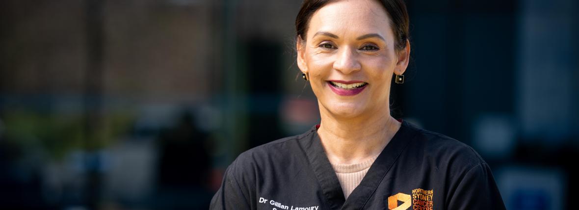 Digitally enabled outcome - Ensuring that health and wellbeing services are connected, safe, secure and sustainable. Smiling female hospital staff member in dark blue uniform