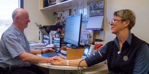 Dr Chris Harrison with patient in office